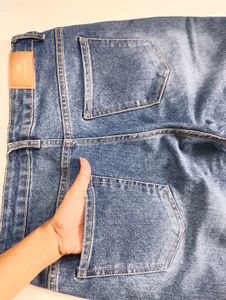 Flared Blue Jeans with Button Detail