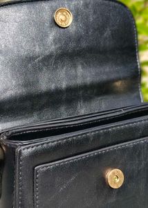 Chic Black Handbag with Gold Embellishment