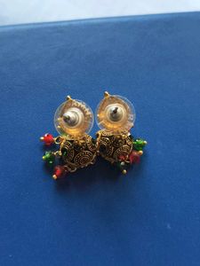 Rustic Gold Jhumka With Red and Green Beads
