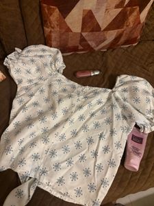 Puff sleeve tie-front top in a soft blue print.