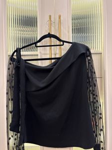 Chic Black Top with Polka Dot Sleeves