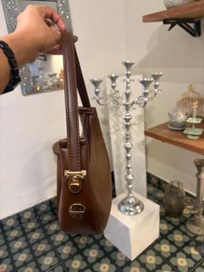 brown sling bag with belt