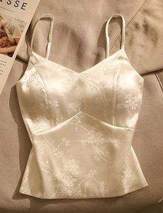 Off-white satin strappy top.