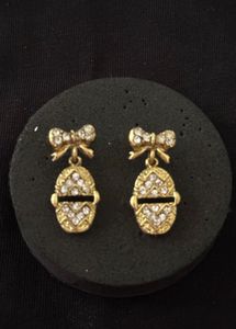 Gold Tone Bow Egg Dangle Earrings
