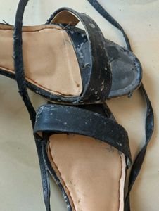 used worn black tie up heels