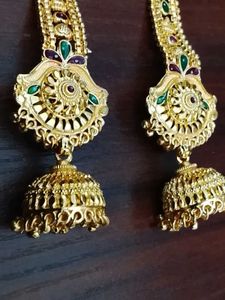 Gold Jhumka Earrings with Green Stones
