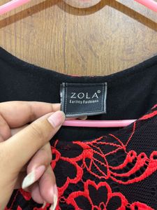 Black lacy dress with red floral detailing