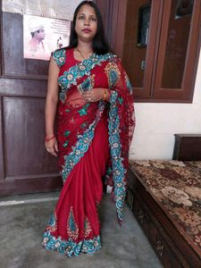 maroon color net saree with stiched blouse