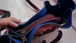 Charming Burgundy Handbag with Floral Embellishmen