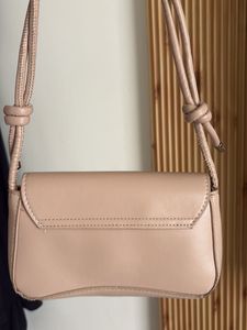 chic nude color side bag with golden buckle
