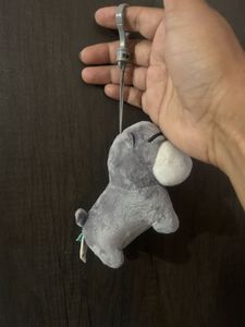 grey and white plush puppy keychain with closed