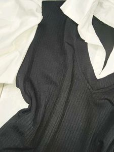 A great black top with white sleeves and collar.