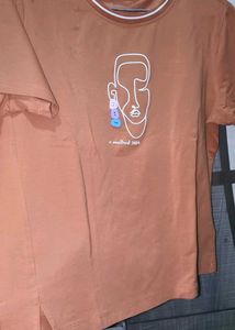 Orange Graphic T-Shirt with Ripped Jeans