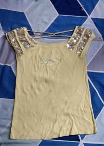yellow crop top with silver detailing on sleves