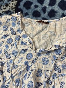 white top with blue botanical prints