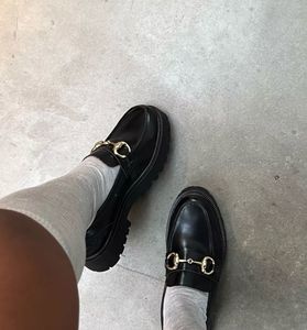 Chic Black Loafers with Gold Bit Detail