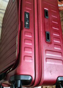 Maroon Hard Shell Luggage Handel grip is broken