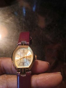 Elegant Gold Tone Watch with Burgundy Band