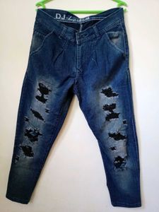 men's heavily distressed / ripped blue denim jeans