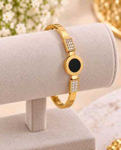 Elegant Gold Bangle with Black & Crystal Accents