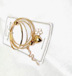 Set of 4 Gold Bangles with Charms