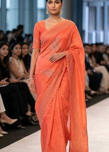 Orange colour shimmer net saree with piece of blou