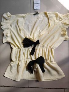 Cream Textured Peplum Top with Bows