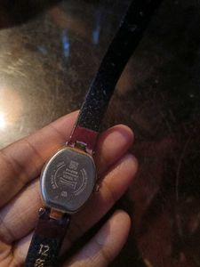Elegant Gold Tone Watch with Burgundy Band