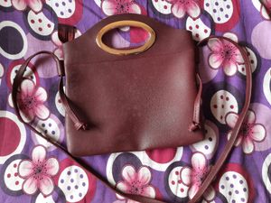 ladies maroon sling bag peacock laser cut