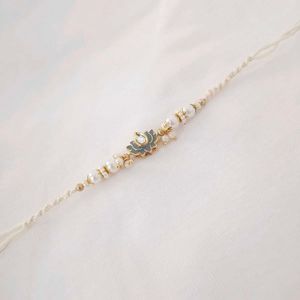 Elegant Pearl Rakhi with Lotus Pendant