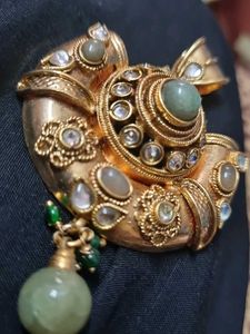 Designer Gold Tone Pendant with Green Stones