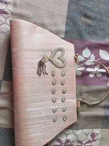 Elegant Pink Clutch with Heart Embellishment