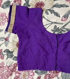 Pink colour saree with golden and purple border.