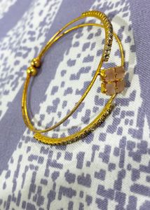 Elegant Gold-Tone Bangle with Gemstones