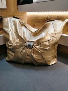 chic gold tote bag with bow accent