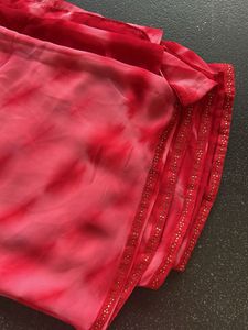 Stunning red tie-dye saree with unique embellishme