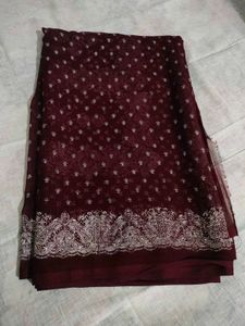 Burgundy saree having white design print.