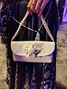 Elegant Woven Clutch Bag with Flower Detail