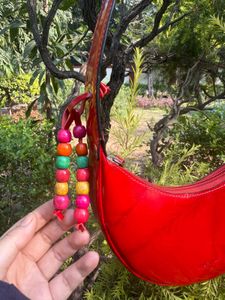 Shop Mistry Red Patent moon bag