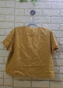 mustard-colored, short-sleeved top