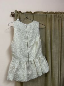 The ivory peplum top
