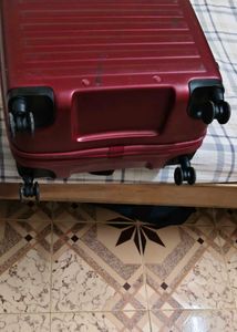 Maroon Hard Shell Luggage Handel grip is broken