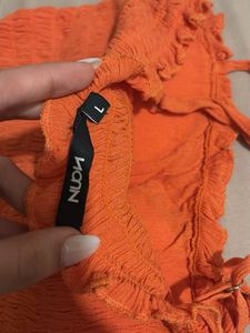orange smocked sleeveless top