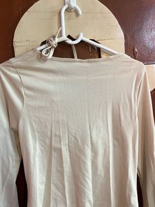 beige top with unique and catchy neckline