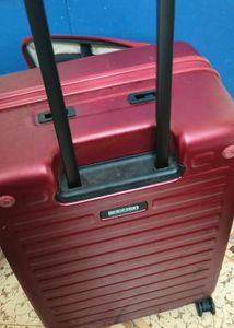 Maroon Hard Shell Luggage Handel grip is broken