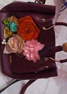 Charming Burgundy Handbag with Floral Embellishmen
