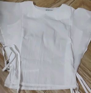 White Top With Shoulder Frill And Knot Style.
