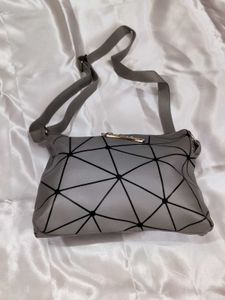 Grey geometric sling bag