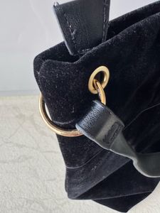 Chic Black Suede Shoulder Bag with Tassel Detail