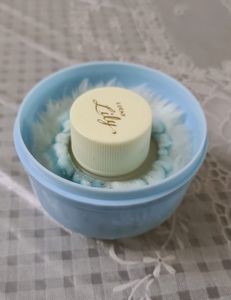 Baby powder puff with a refill container